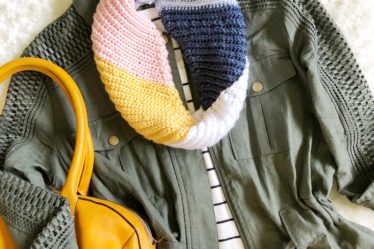 Multicolored crochet scarf with diagonally ribbed texture made with the Kelsi Scarf pattern shown in flat lay.